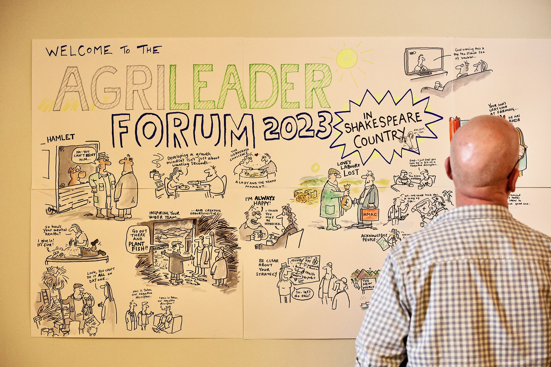 Artist drawing cartoons portraying discussion points from conference